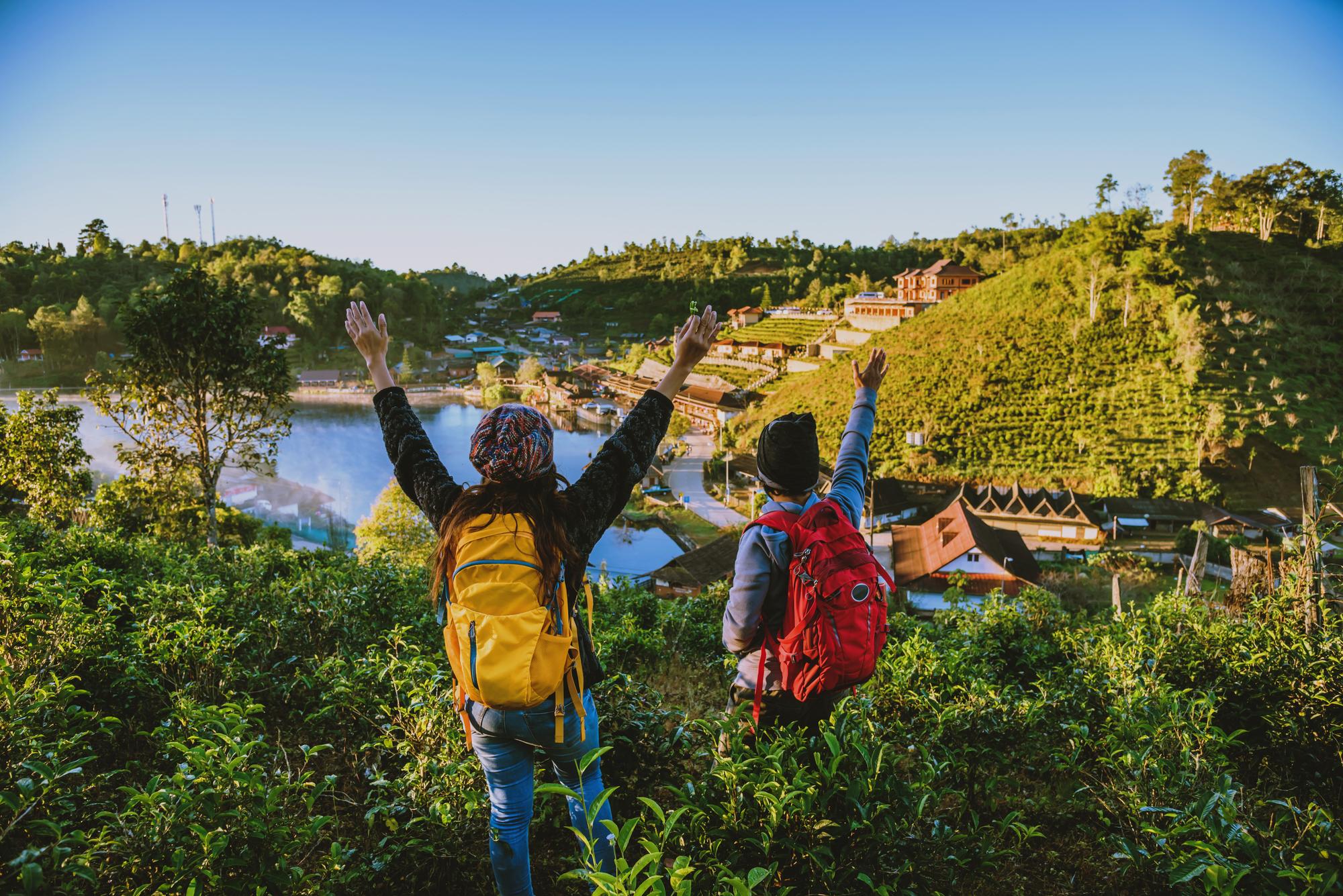 two people standing with arms outstretched mountain in Europe