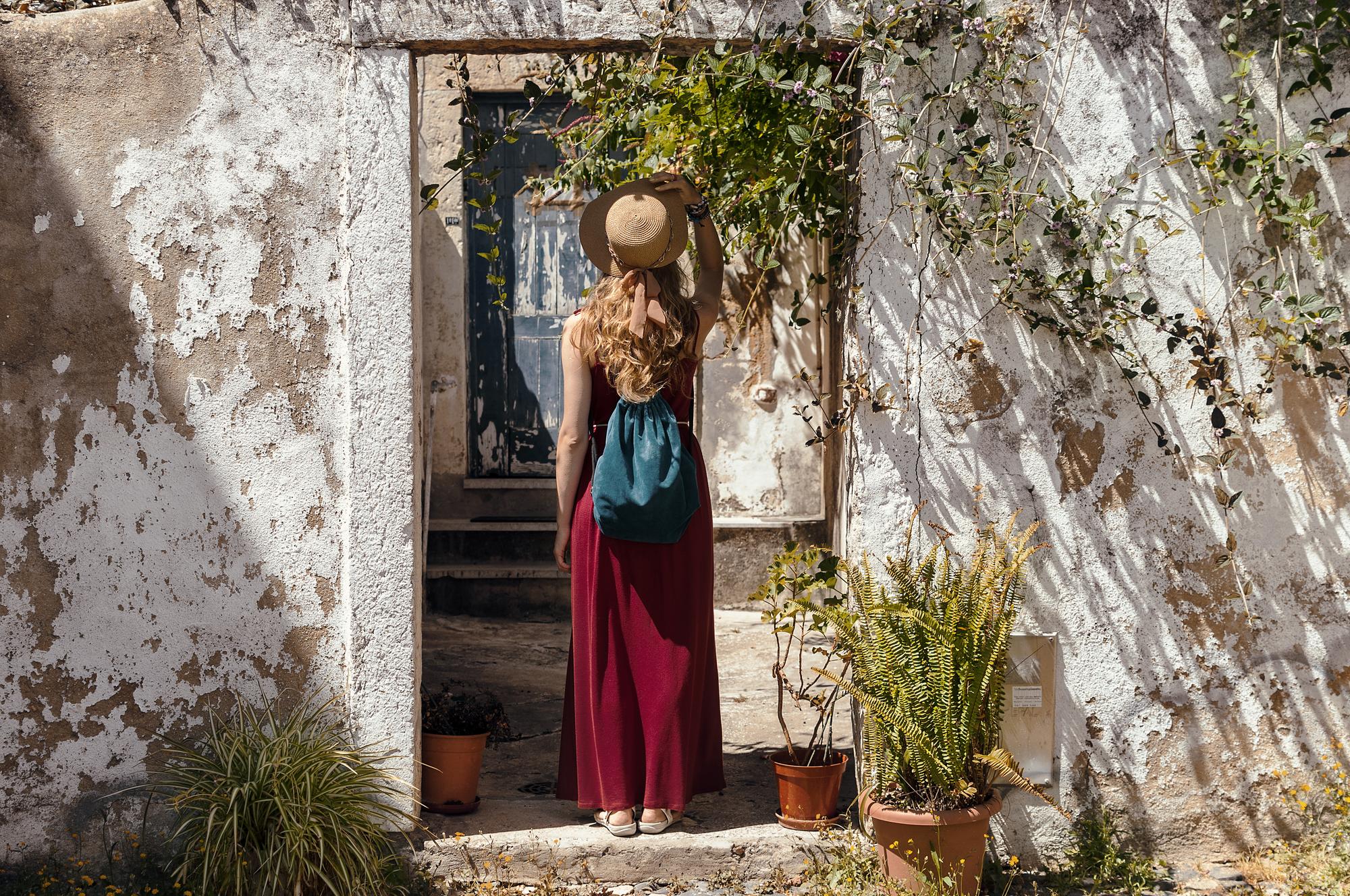 woman-standing-against-door-sunny-day