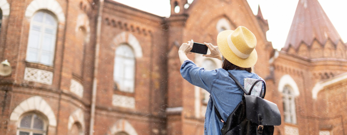 stylish-traveller-with-hat-taking-pictures-holiday